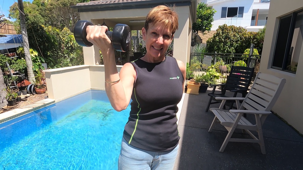 A Scuba Woman lifting a weight with a swimming pool in the background
Empty Nest Diver